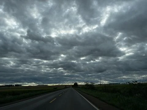 Dramatic cloudy sky over a rural road in Ibiruba, Rio Grande do Sul, Brazil Stock Photos