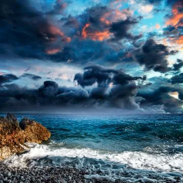 Dramatic cloudy sky over the sea. Stock Photos