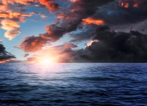 Dramatic cloudy sky over the sea. Stock Photos