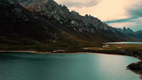 Dramatic Cloudy Sky Over Turquoise Lakes and Rugged Mountains Western Sichuan Stock Footage 346423519
