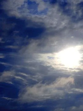 Dramatic cloudy sky with sun breaking through Stock Photos