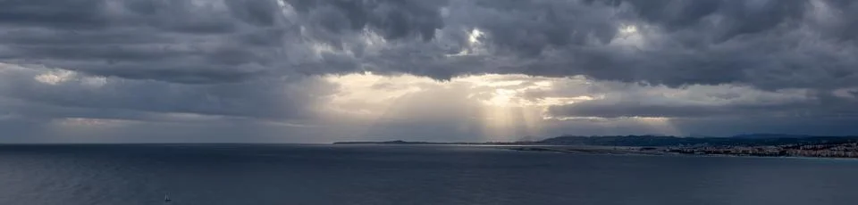 Dramatic Cloudy Sky with Sunrays on the Coast. Cloudscape Background Stock Photos