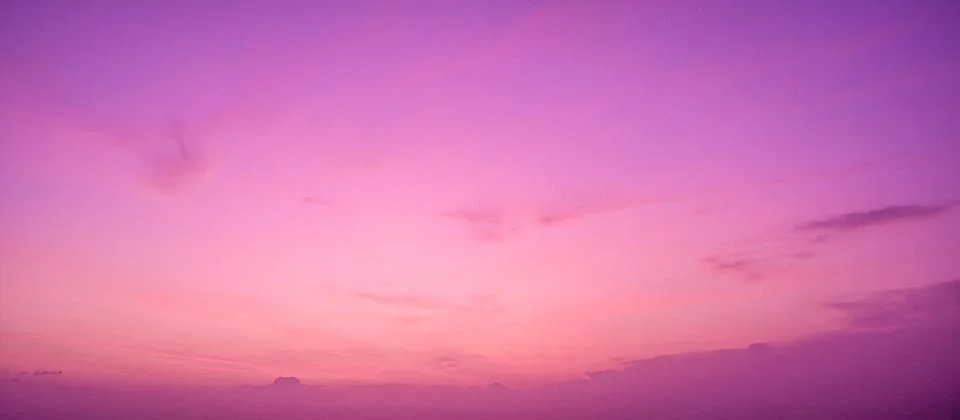 Dramatic cloudy sky at sunset with beautiful pink, purple and orange colors.. Stock Photos