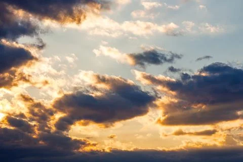 Dramatic cloudy sky in warm evening glow Stock Photos