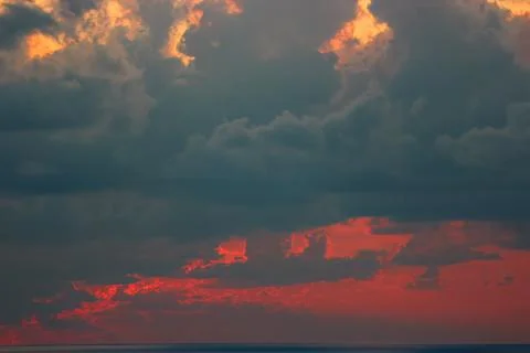 Dramatic Cloudy Sunset over a Body of Water Stock Photos