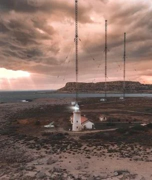 Dramatic Cloudy Sunset Over Cape Greco Peninsula with Iconic Lighthouse and.. Stock Photos