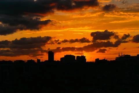 Dramatic cloudy sunset sky with the setting sun over the city, Istanbul Photos