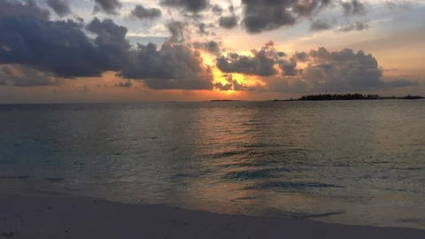 Dramatic cloudy sunset on the tropical island. Maldives. 4K Stock Footage 128198048