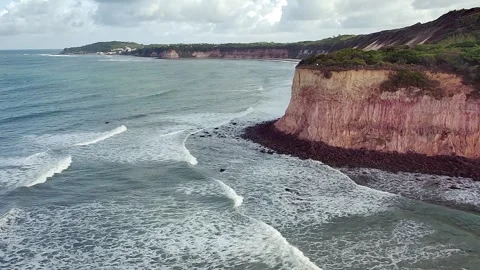 Dramatic coastal cliffs and ocean waves at Praia de Pipa, Brazil. Video stock 314401575