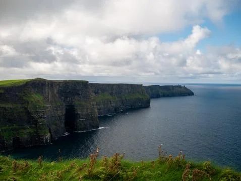 Dramatic coastal cliffs and ocean landscape Stock Photos