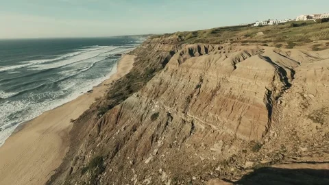 Dramatic coastal cliffs meet crashing waves below Stock Footage 341826638