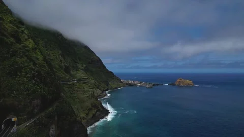 Dramatic Coastal Cliffs Meet The Ocean Under A Cloudy Sky. Stock Footage 324506250