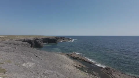 Dramatic coastal cliffs overlooking calm blue atlantic ocean water in ireland Stock Footage 340457738
