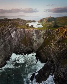 A Dramatic Coastal Landscape Captured at Sunset, Rugged Cliffs and Ocean Waves Stock Photos