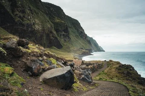 Dramatic Coastal Landscape with Steep Cliffs, Winding Path, and Ocean Views.. Stock Photos