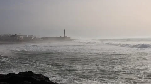 A dramatic coastal scene featuring powerful ocean waves rolling toward the shore Stock Footage 336536641