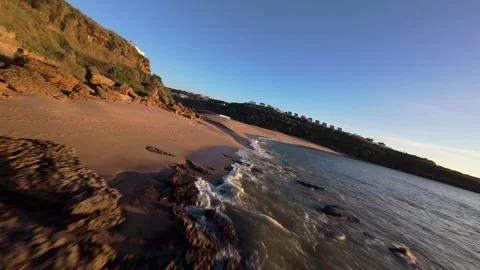 Dramatic coastal scene with sunlight reflecting off ocean waves Stock Footage 344562254