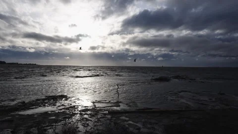 Dramatic Coastal Seascape with Cloudy Sky and Glinting Sunlight Stock Footage 271200871