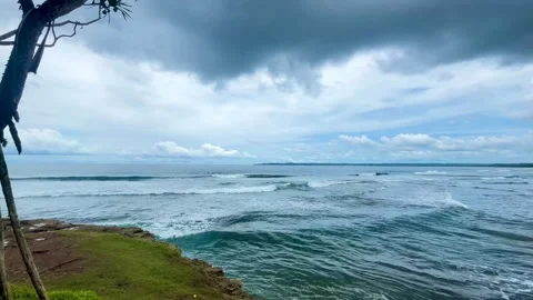 Dramatic Coastal View of Ocean Waves Breaking Under Cloudy Sky Stock Footage 341035985