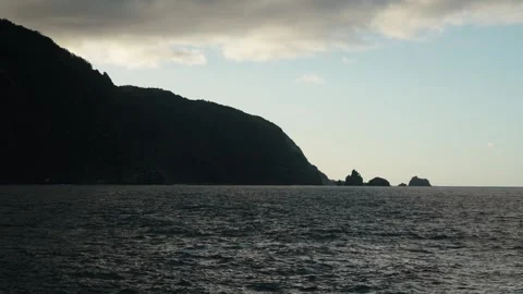 Dramatic coastal view of Seixal, Madeira with silhouetted cliffs and sea stacks Stock Footage 312030683