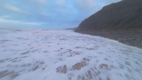 Dramatic coastal view with turbulent ocean and cliffside Video stock 344674672