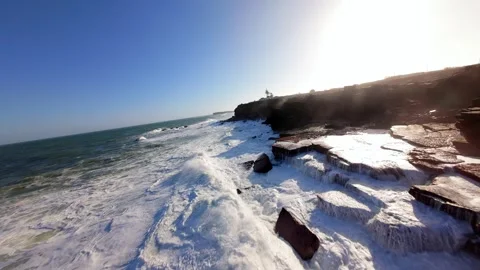 Dramatic coastline with crashing waves at golden hour Video stock 346076517