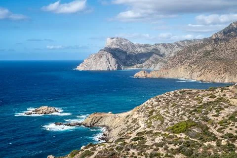 Dramatic coastline meeting deep blue sea in remote island paradise, Karpath.. Stockfoto's