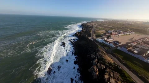 Dramatic coastline with powerful waves breaking on dark rocks at Peniche Video stock 346076210