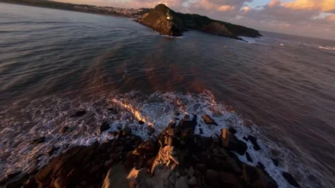 Dramatic coastline with vibrant sunset colors Stock Footage 344579608