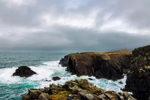 Dramatic coastline with waves crashing into rocks Stock Photos