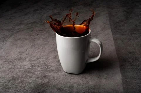 Dramatic Coffee Splash Rising from Mug Foto stock