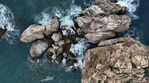 Dramatic color of the sea, waves crashing against the rocks, aerial view on a Stock Footage 225078232