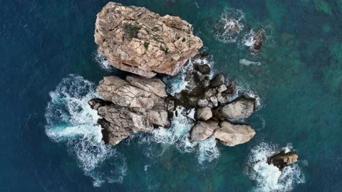 Dramatic color of the sea, waves crashing against the rocks, aerial view on a Stock Footage 225078457