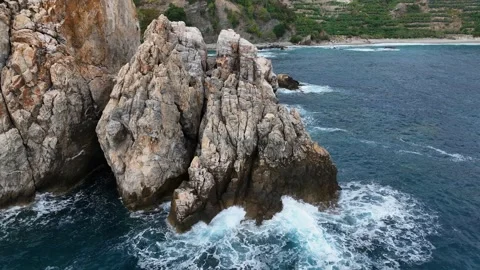 Dramatic color of the sea, waves crashing against the rocks, aerial view on a Stock Footage 225082340