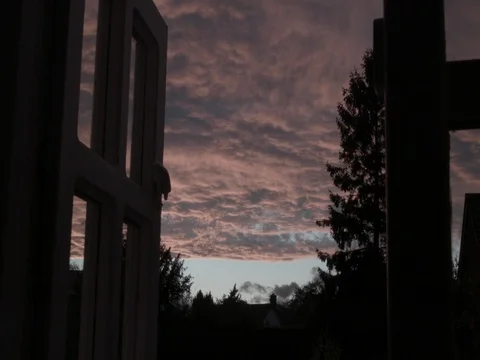 Dramatic colorful  clouds moving in the sky viewed from a window 스톡 동영상 77807012