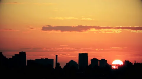 Dramatic colorful red fiery sunset timelapse sky landscape with line row of city Stock Footage 138099326