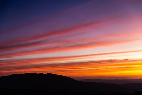 Dramatic colorful sky and clouds in pattern at sunset. Stock Photos