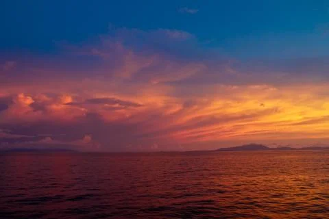Dramatic colorful sunset on endless ocean horizon Stock Photos