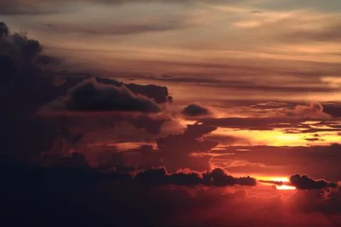 Dramatic colorful sunset with heavy dark clouds Stock Photos