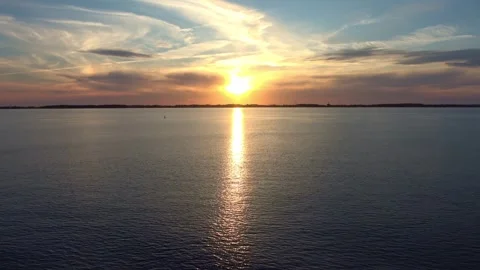 Dramatic colorful sunset over the sea with the sun's reflection creating a Stock Footage 343321731