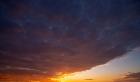 Dramatic Colorful Sunset Sky. Clouds with Sunrays. Cloudscape Sunset Background Stock Photos