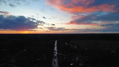 Dramatic Colorful Sunset Sky Over Wind Farm Horizon Stock Photos