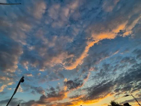 Dramatic colorful sunset sky with scattered clouds Stock Photos