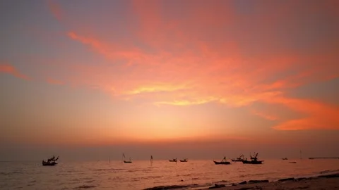 Dramatic colorful warm and cloud sunset over the sea with fish boats Stock Footage 240723999