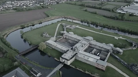 Dramatic colors of  drone aerial over fort Breendonk, a former nazi prison Stock Footage 163432133