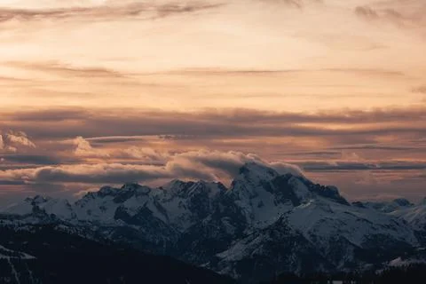 Dramatic colors effect of dolomite winter panorama at sunset with sunlit clouds Stock Photos