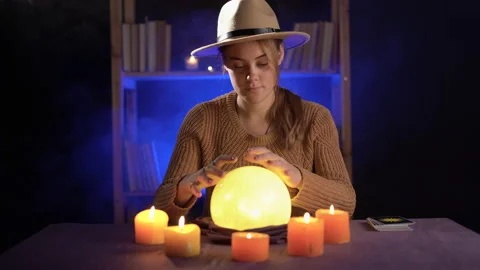 Dramatic concept of a mystic, female young fortune teller with a lighted crystal Stock Footage 221822920