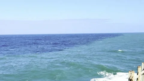 Dramatic Contrast Where Deep Blue and Turquoise Ocean Waters Meet Stock Footage 330313202