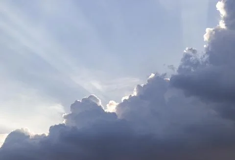 Dramatic Crepuscular Sun Rays Beaming Behind Dark Cumulus Clouds. Stock Photos