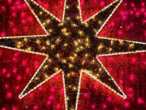 Dramatic crimson star symbol featuring radiant lighting and high contrast f.. Stock Photos